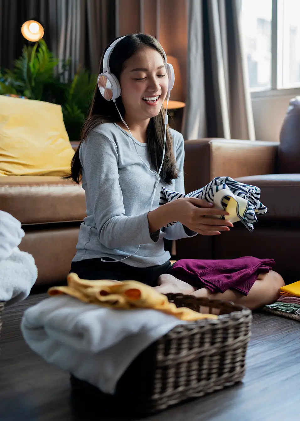 young woman folding laundry